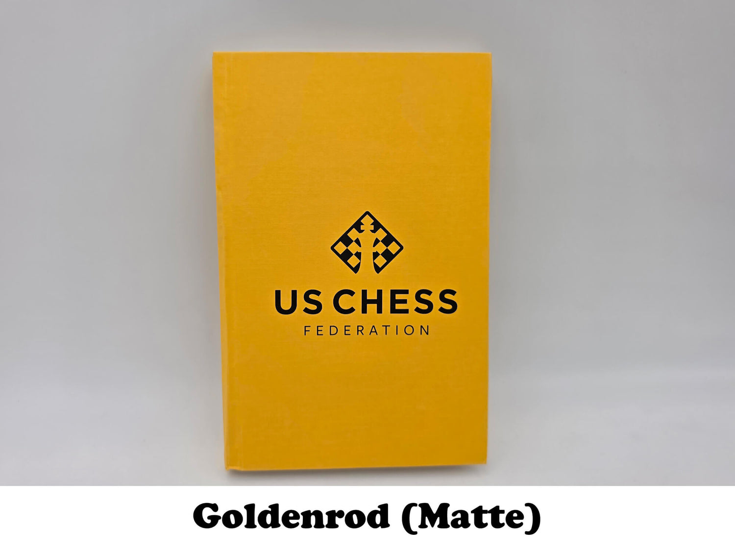 Bright goldenrod matte USCF chess scorebook for tournament games.