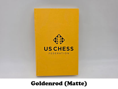 Bright goldenrod matte USCF chess scorebook for tournament games.