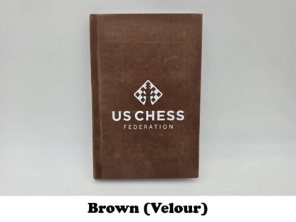 Soft brown velour USCF chess scorebook cover with official logo stamp.