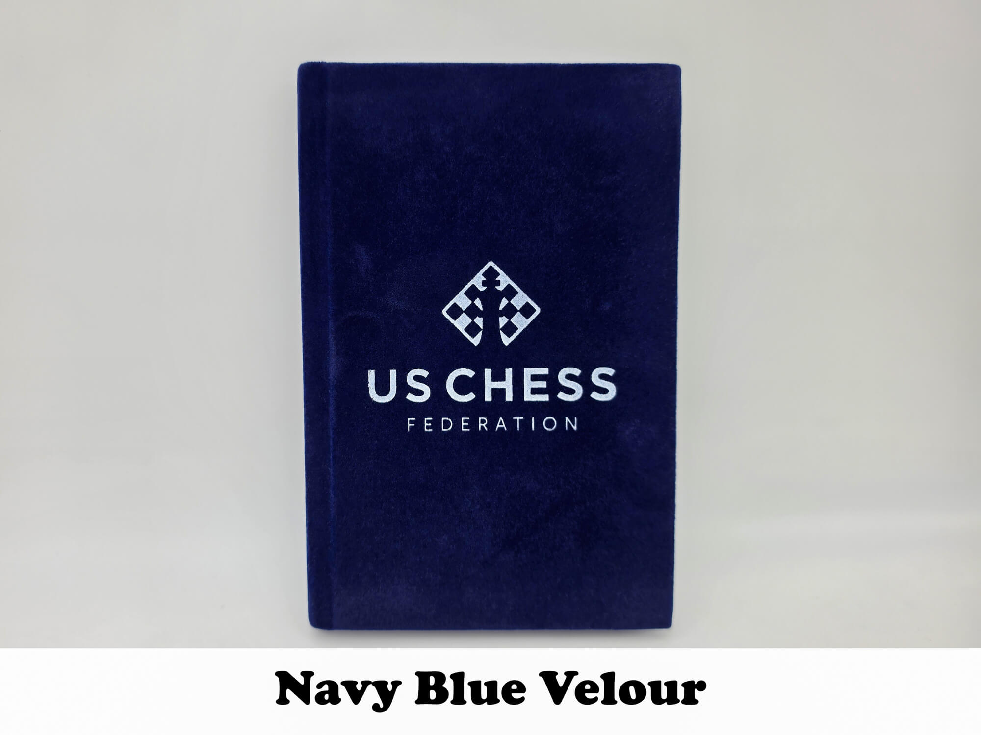 Deep navy blue velour USCF tournament chess scorebook.
