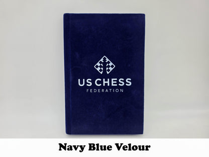 Deep navy blue velour USCF tournament chess scorebook.