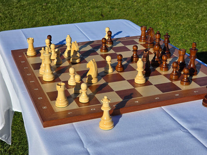 Side profile view of a premium wooden chess set with pieces arranged on a mahogany board.